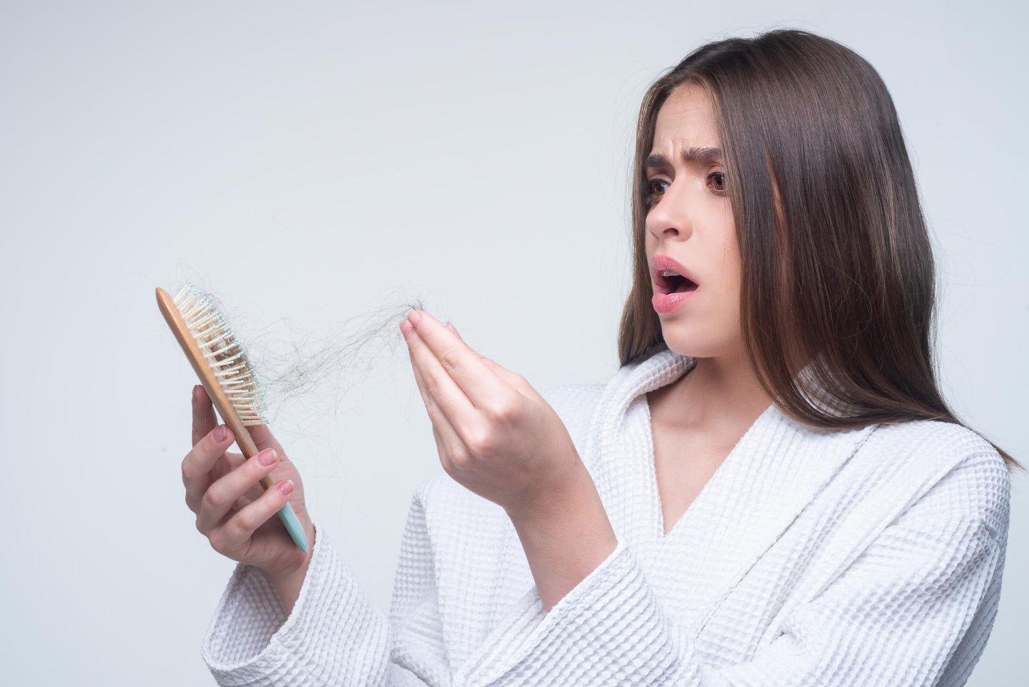 Woman looking at her hair brush